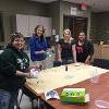 Early Childhood Student Organization students around craft table with tie die.